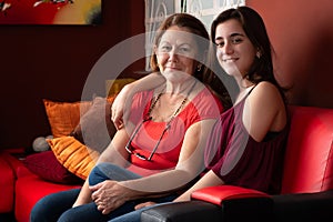 Hispanic teenage girl and her grandmother at home