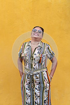 Portrait Of Hispanic Woman Standing Against Wall