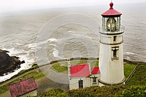 Portrait of the historic Heceta head lighthouse on a foggy day.