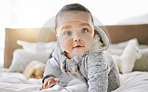 Portrait, home and baby on a bed, relax and happiness with wellness, playful and rest. Face, male kid and infant in a