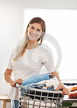 Portrait, home and woman with a laundry basket, smile and cleaning with chores, housekeeping and hygiene. Face, female
