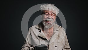 Portrait of a homeless, caucasian man looking carefree and cheerful