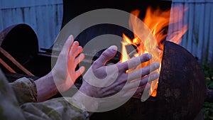 Portrait of Homeless man in front of a fire, close up