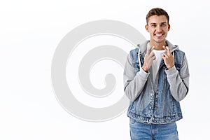 Portrait of hopeful, optimistic male student cross fingers good luck, beaming smile anticipate good news, relish