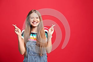 Portrait of hopeful woman with crossed fingers