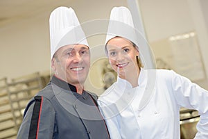 Portrait hospitable chef and helper at restaurant