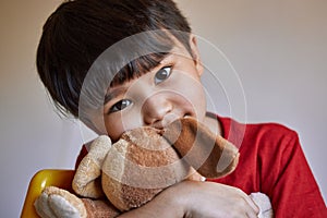 Portrait, house and happy boy with stuffed animal, relaxed and childhood development for growth and comfort. Indian