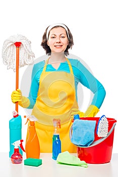 Portrait of a housewife with a mop and cleaning agents