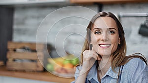 Portrait of housewife smiling posing at domestic kitchen. Medium close up shot on 4k RED camera