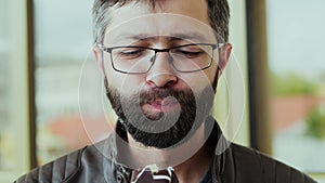 Portrait of hungry bearded man eating chocolate ice cream lolly