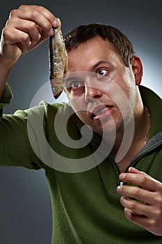 Portrait of hungry man staring at fish