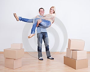 Portrait Of Husband Holding Wife In New Home