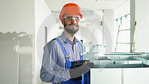 Portrait of hvac worker with ventilation pipes on construction site