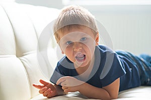 Portrait of hysterical boy. Upset caucasian kid crying at home.