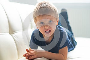 Portrait of hysterical boy. Upset caucasian kid crying at home.