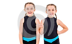 Portrait of identical twin girls dressed in rhythmic gymnastics dress