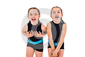 Portrait of identical twin girls dressed in rhythmic gymnastics dress