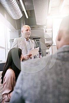 Portrait image of professional businessman giving a presentation to peers