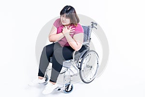 Portrait images of Asian fat woman sitting on a wheelchair having a heart attack