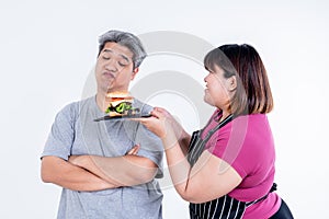 Portrait images of Asian wife Obese persuading her husband To eat a hamburger photo