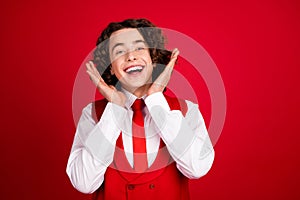 Portrait of impressed cheerful young man arms palms applaud empty space isolated on red color background