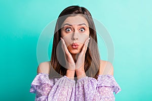 Portrait of impressed stressed girl hands face open mouth wear purple shirt isolated on blue color background