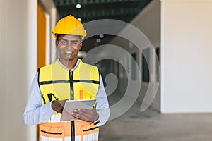 portrait indian engineer forman staff worker standing happy smiling in cargo factory indoor with tablet photo