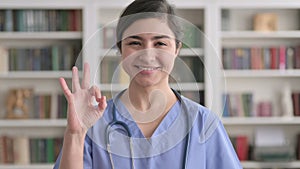 Portrait of Indian Female Doctor showing Ok Sign with Finger