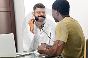 Portrait of indian man doctor talking to patient on consultation