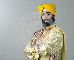 Portrait of Indian sikh man with bushy beard with his arms crossed