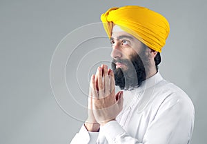 Portrait of Indian sikh man with a bushy beard praying