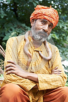 Portrait of indian snake charmer man in turban in India