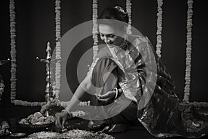 Portrait of Indian Woman celebrating Diwali festival by Lighting the lamp