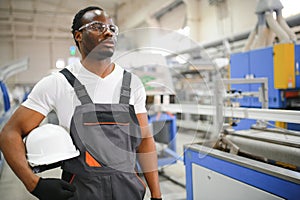 Portrait of industrial engineer. factory worker standing in factory production line