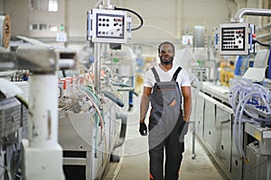 Portrait of industrial engineer. factory worker standing in factory production line