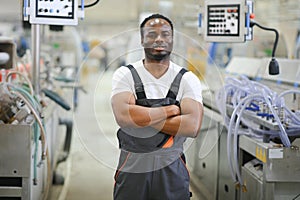 Portrait of industrial engineer. factory worker standing in factory production line