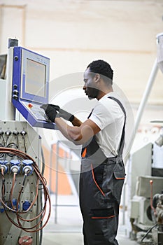 Portrait of industrial engineer. factory worker standing in factory production line