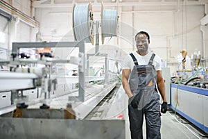 Portrait of industrial engineer. factory worker standing in factory production line