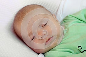 Portrait of infant little girl sleeping in her bed at home