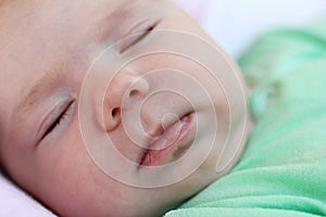 Portrait of infant little girl sleeping in her bed at home