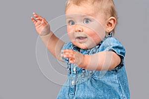 Portrait of infant waving hands