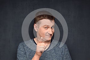 Portrait of insightful man pointing with forefinger at camera