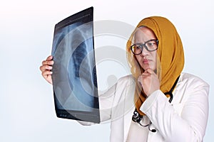 Muslim Female Doctor Examining X-ray Film photo