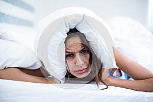 Portrait of irritated woman lying on bed