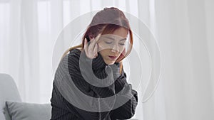 Portrait of irritated young woman closing ears with hands and looking up. Annoyed Caucasian lady suffering from neighbor