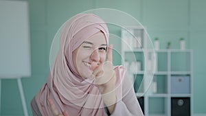 Portrait Islamic happy girl wearing hijab Muslim cheerful woman dancing celebrating victory triumph business winning