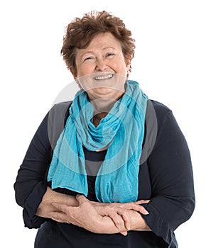 Portrait: Isolated happy pensioner woman wearing blue and turquoise clothes.