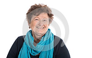 Portrait: Isolated happy pensioner woman wearing blue and turquoise clothes.