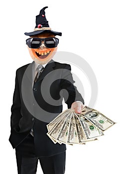 Portrait of Jack Lantern from pumpkin in black business suit. Jack Lantern keeps money in his hands.
