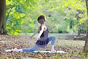 Portrait of Japanese woman doing yoga exercise outdoor